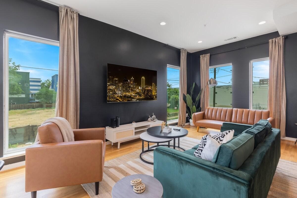 Large windows and natural light in  this modern living room while you catch up on your fave movies and content